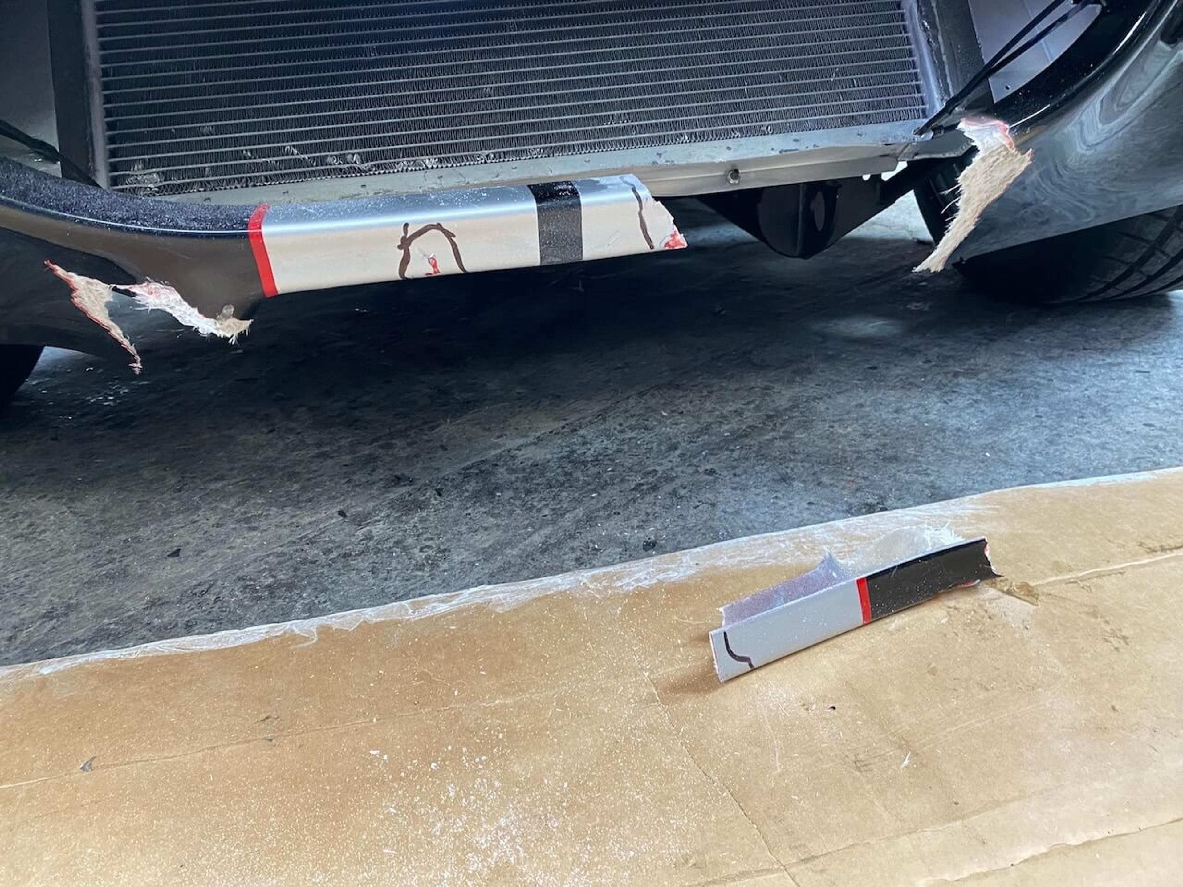 Damaged front valance and lower opening Close-up of cracked and broken fiberglass around the lower front opening of a Shelby Cobra-style roadster