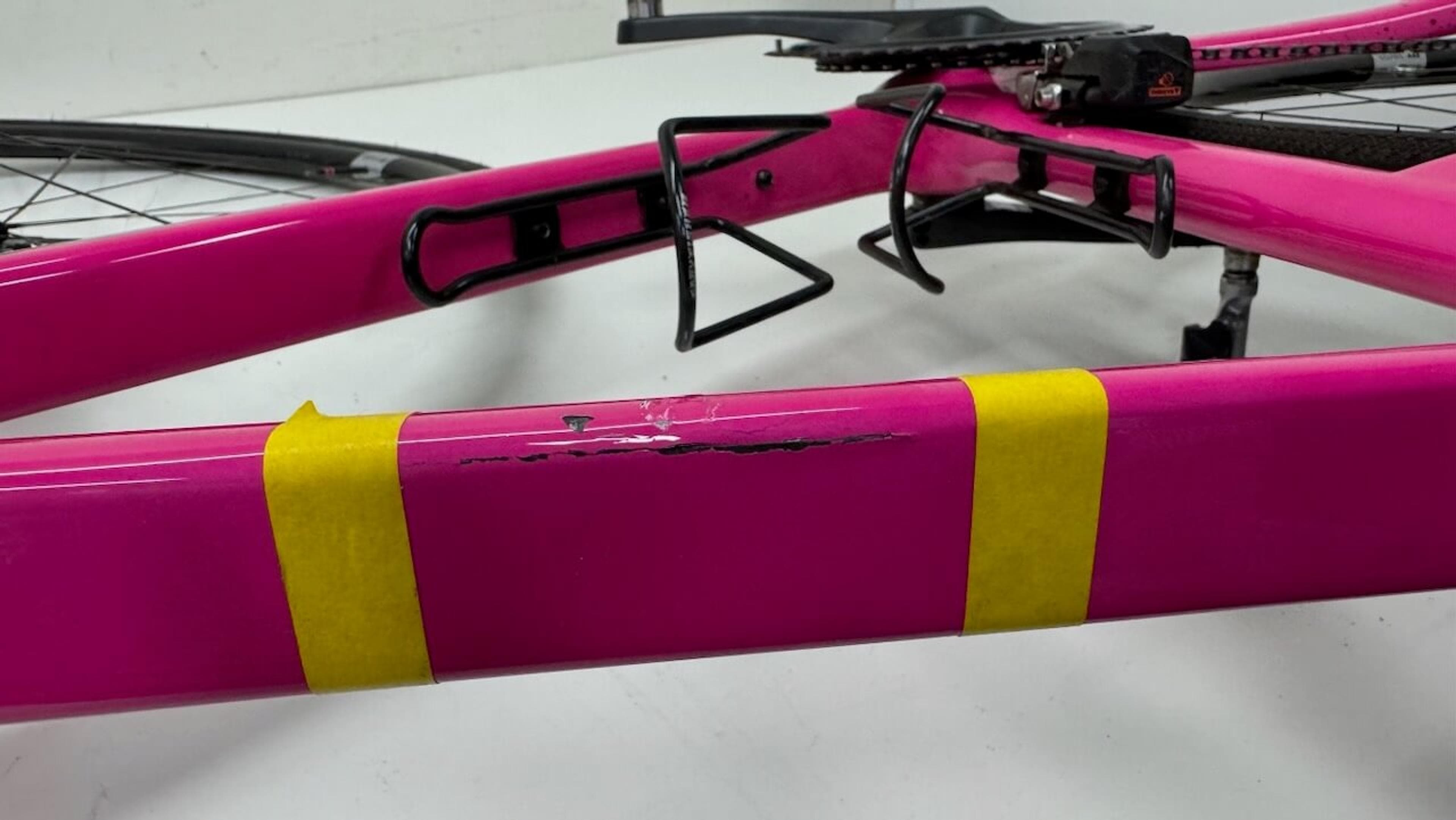 Damaged top tube before repair Side view of cracked Quintana Roo SRfive top tube marked with masking tape