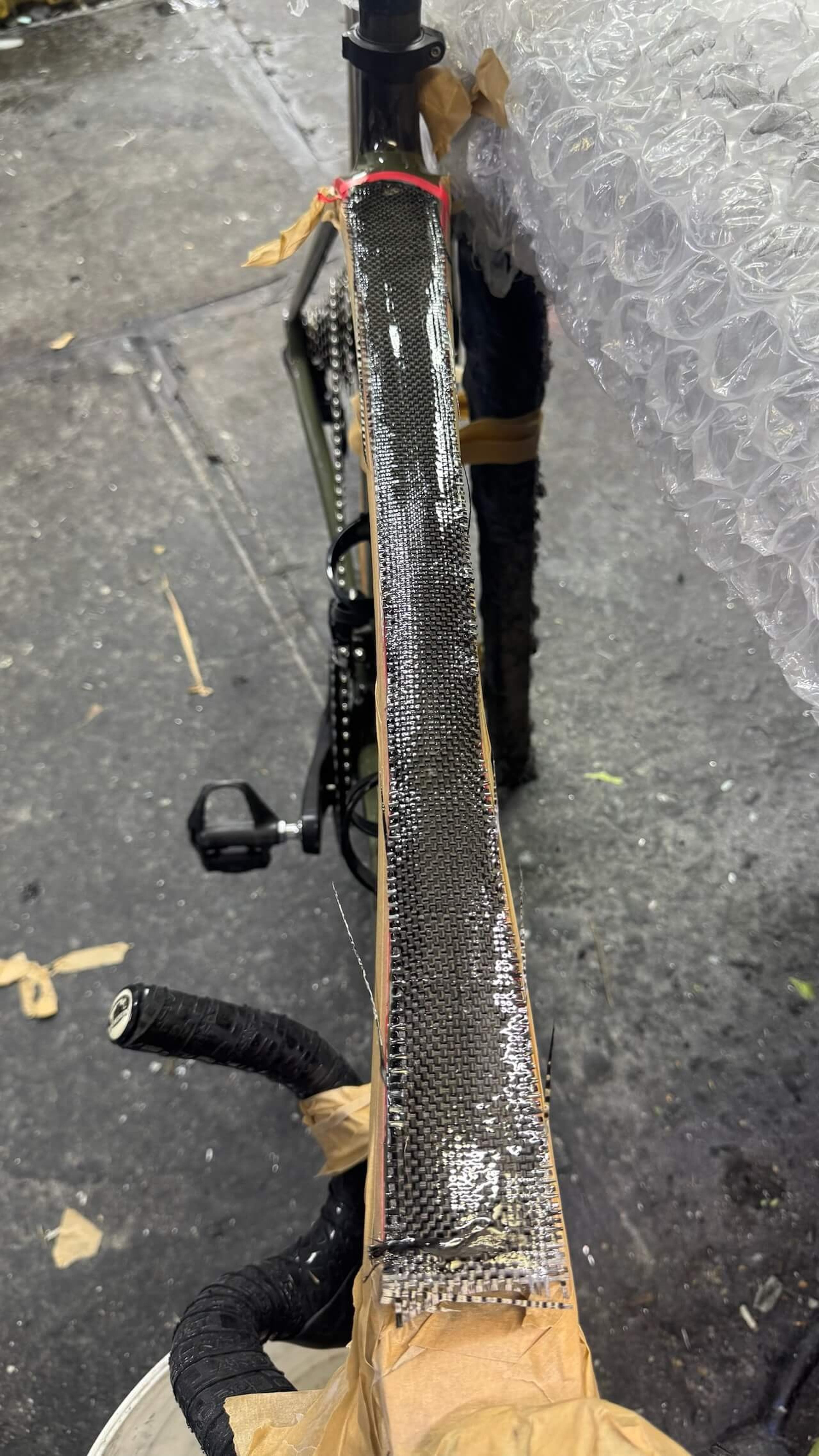 Carbon fiber reinforcement applied Close-up of carbon fiber reinforcement applied to the Trek Émonda SL top tube during frame repair