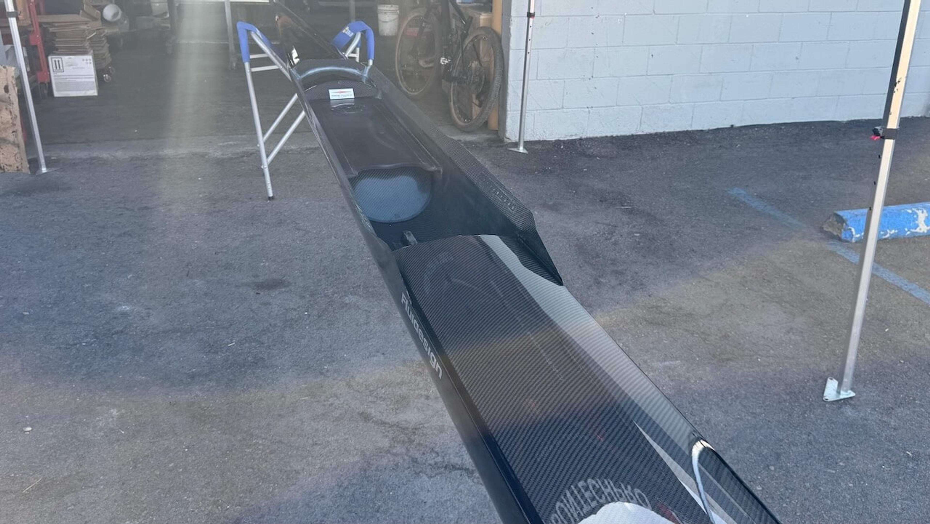 Restored interior carbon fiber Wide interior view of a repaired Fluidesign carbon fiber rowing shell