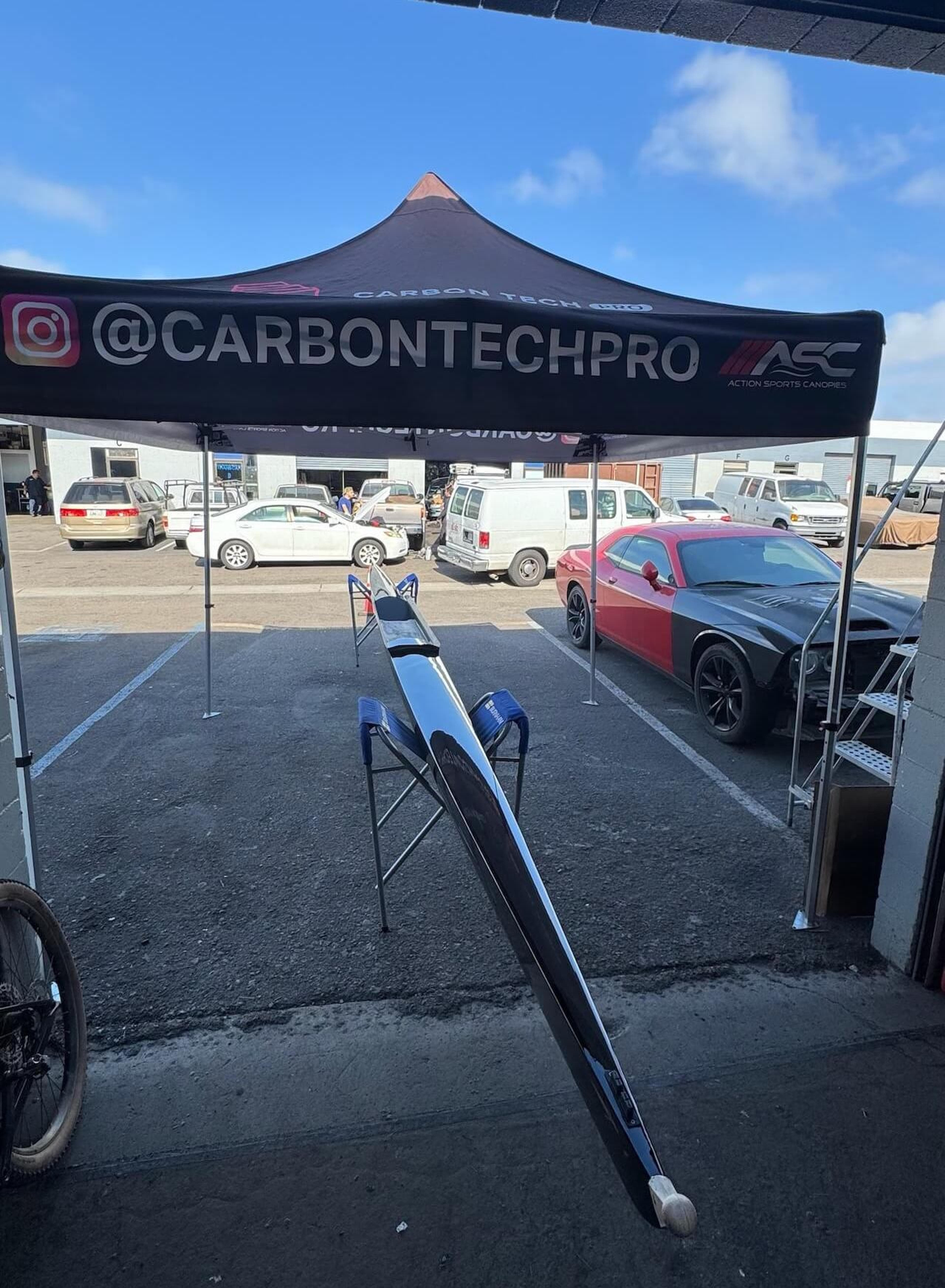 Completed rowing shell repair Full-length Fluidesign carbon fiber rowing shell after repair outside Carbon Tech Pro
