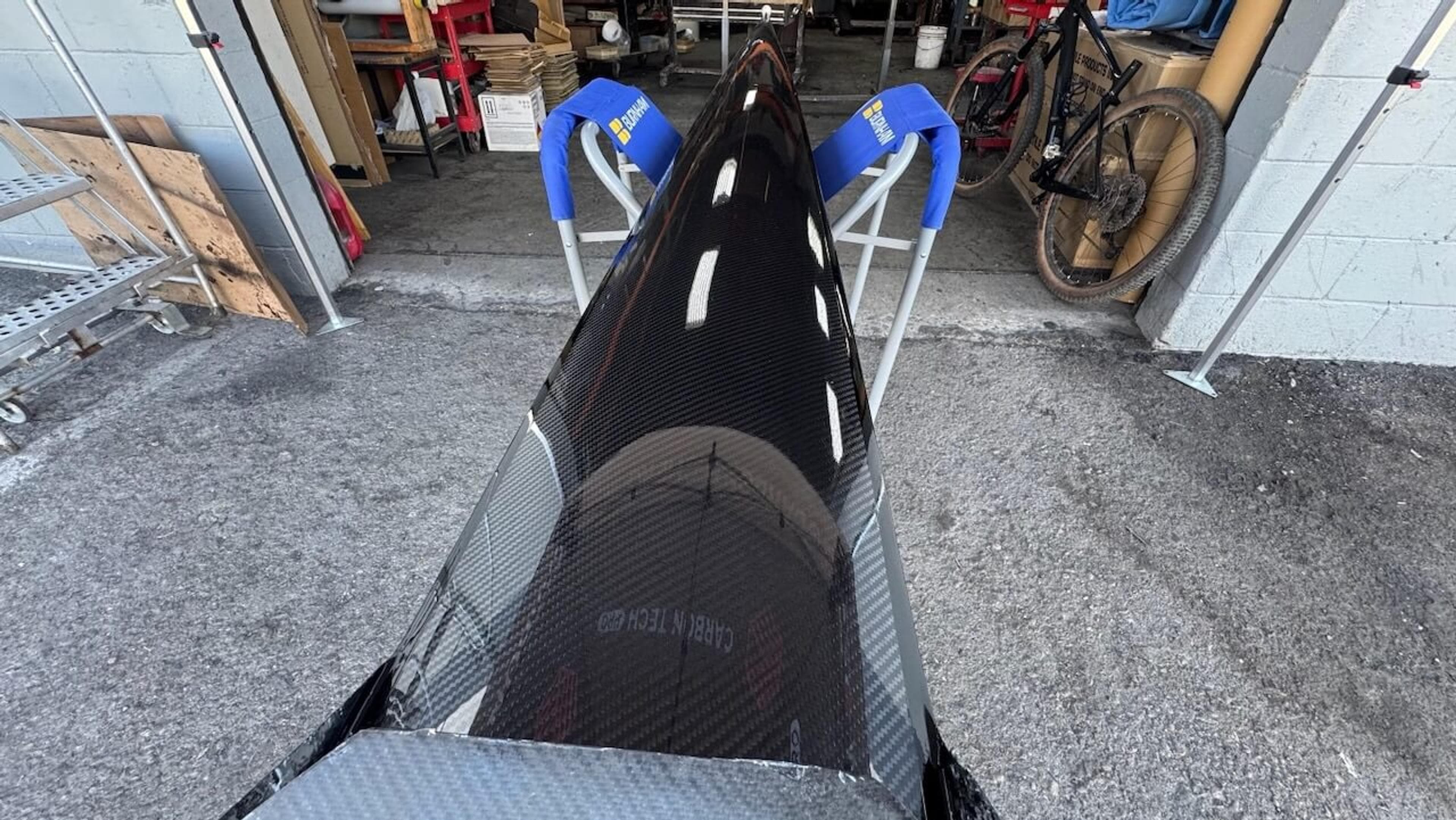 Finished carbon fiber exterior Glossy exterior of a repaired Fluidesign carbon fiber rowing shell