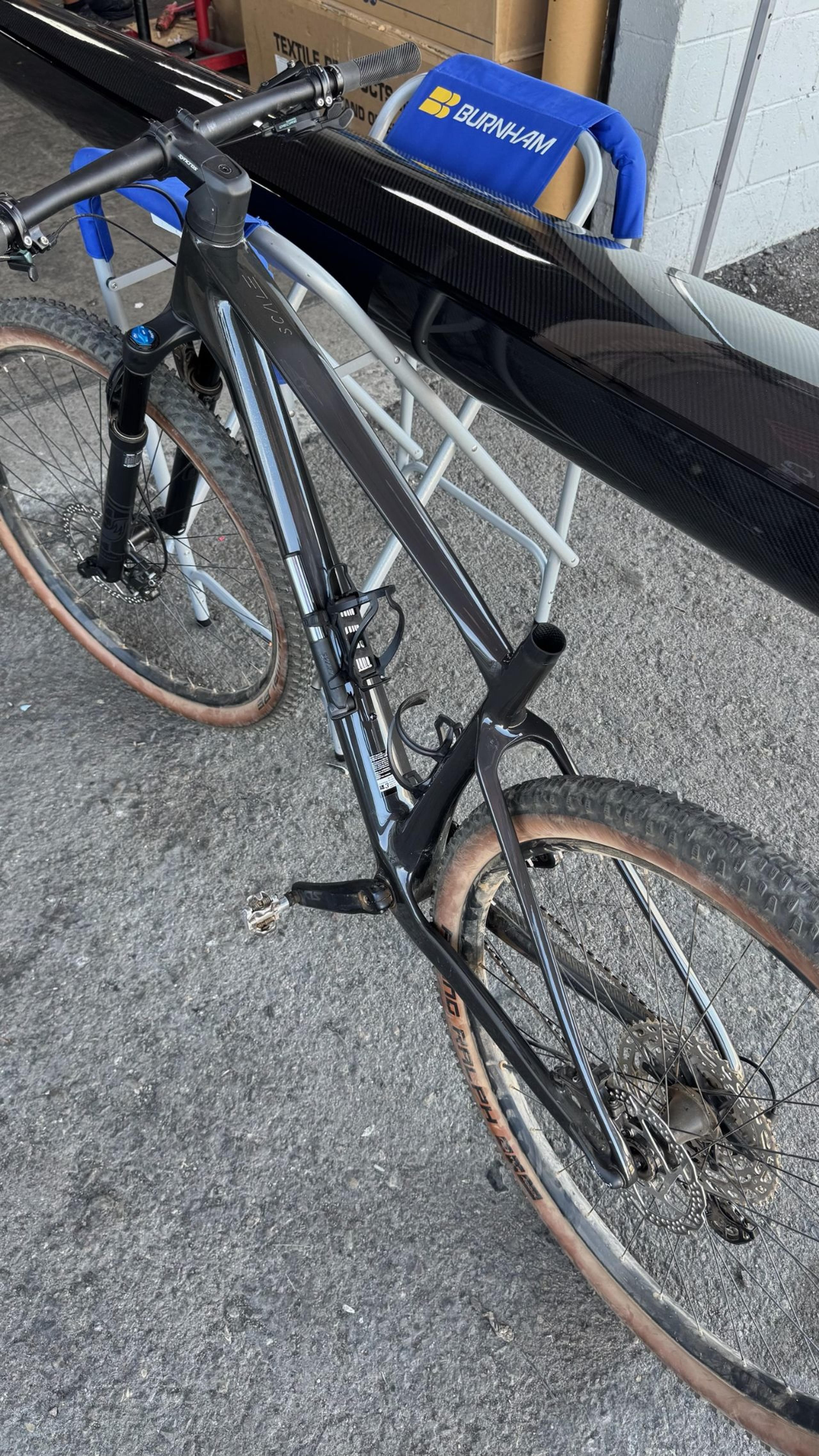 Detailed overhead view of the repaired frame showing the smooth finish across the top tube and down tube. Overhead view of restored Scott Scale RC carbon fiber frame and glossy finish