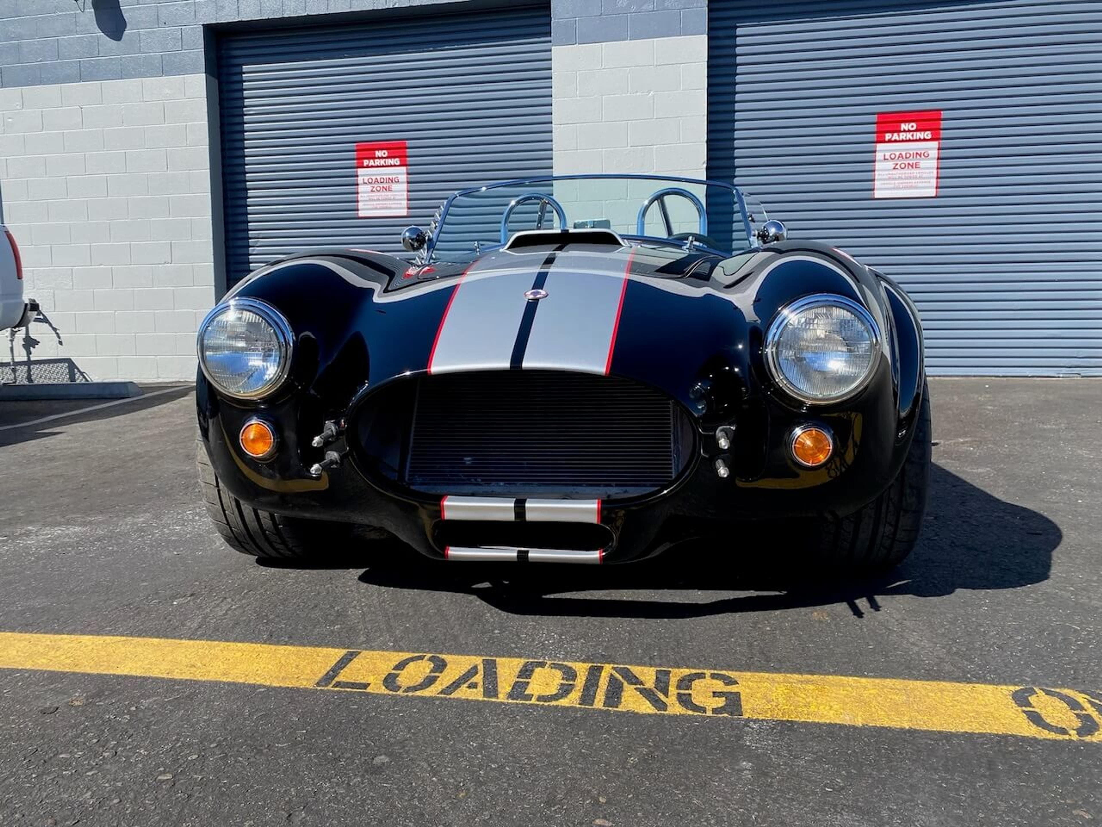 Restored front bodywork Full front view of the Shelby Cobra-style roadster showing the completed fiberglass body repair