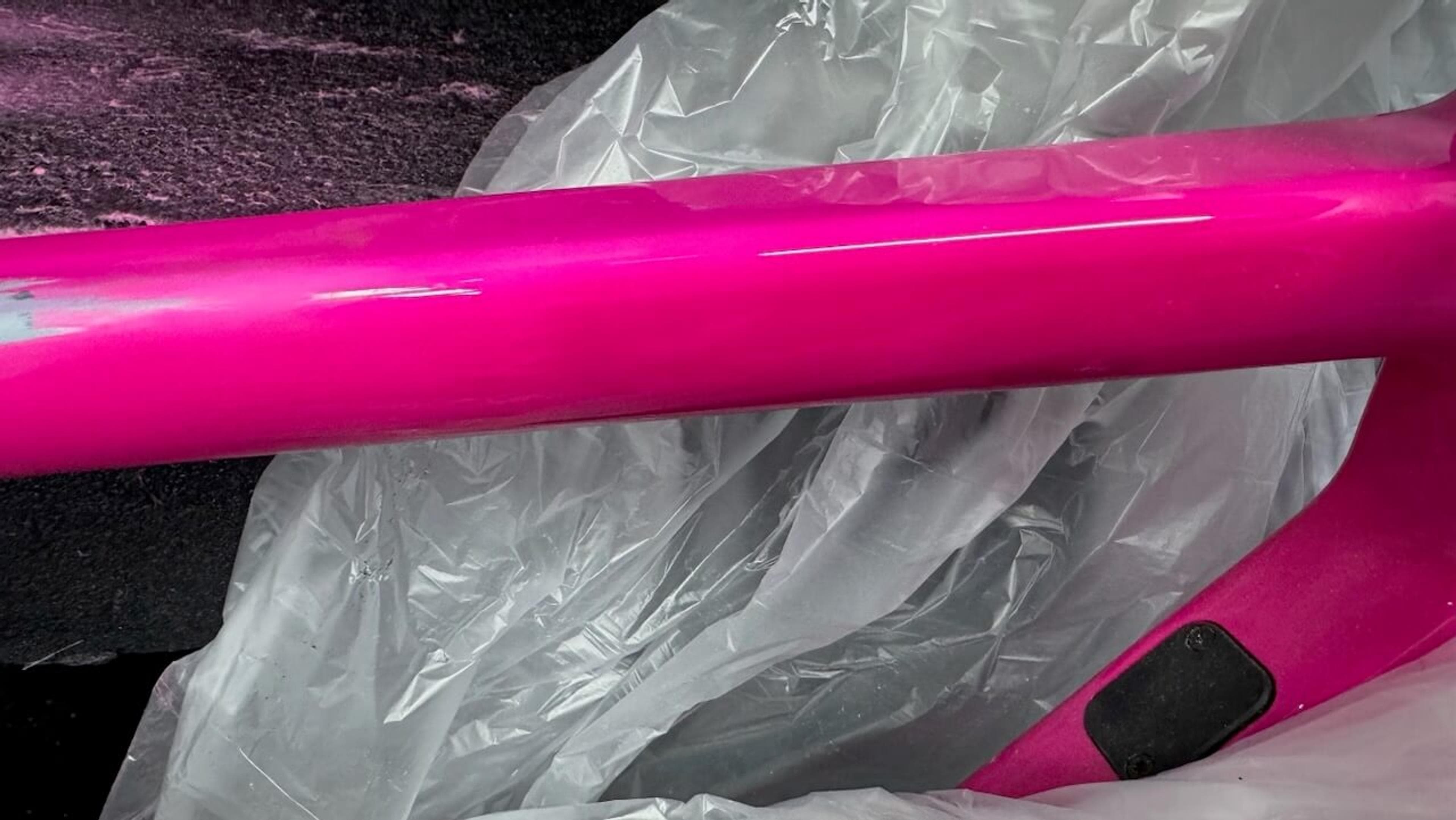 Repaired area refinished to match Repaired Quintana Roo SRfive top tube after refinishing and pink paint restoration