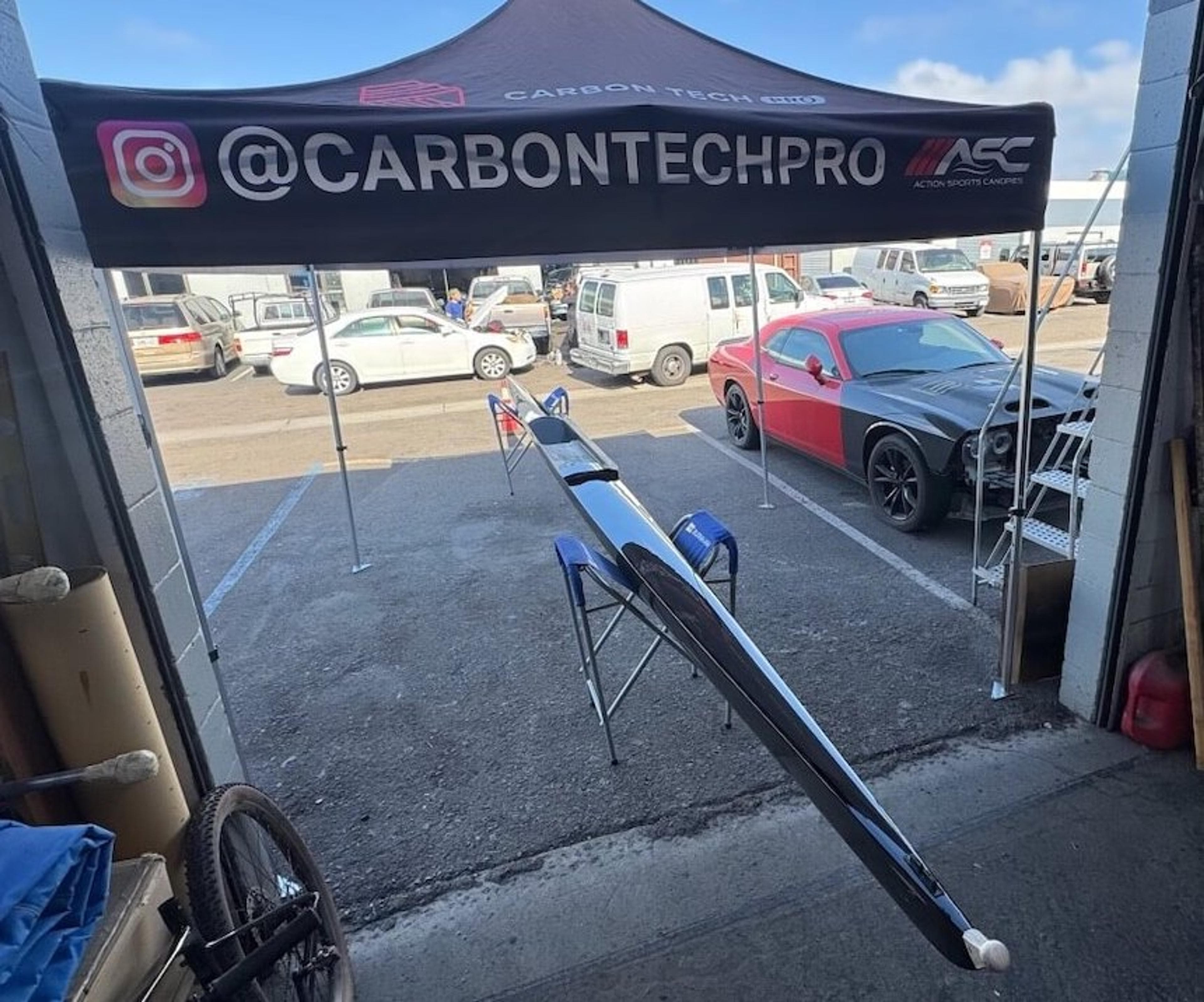 Fluidesign shell at Carbon Tech Pro Full view of a Fluidesign carbon fiber rowing shell outside the Carbon Tech Pro shop