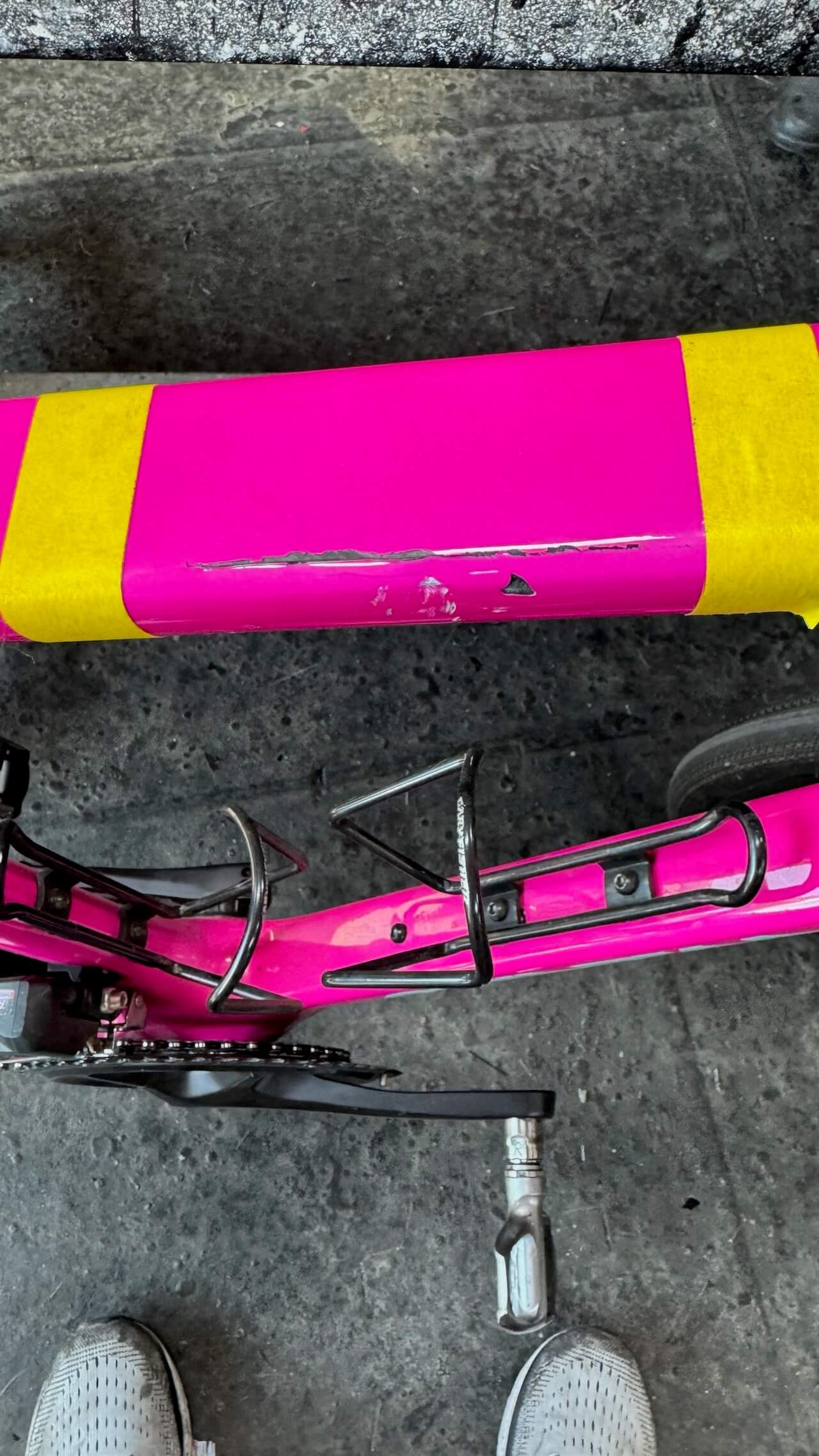 Damaged section marked for repair Close-up of damaged top tube on pink Quintana Roo SRfive carbon fiber road bike